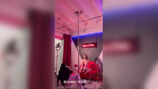 Ur69b4by Models a Red Bodysuit Under Neon Lights in Studio