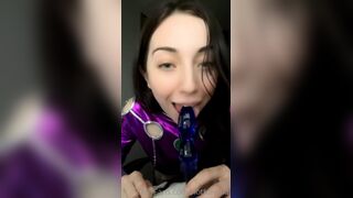 Foreplay Sucks a Blue Dildo Kneeling in a Shiny Purple Costume