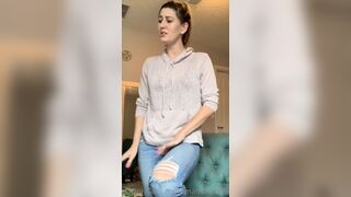 Imamberhahn Adjusts Her Jeans and Casual Outfit in the Living Room
